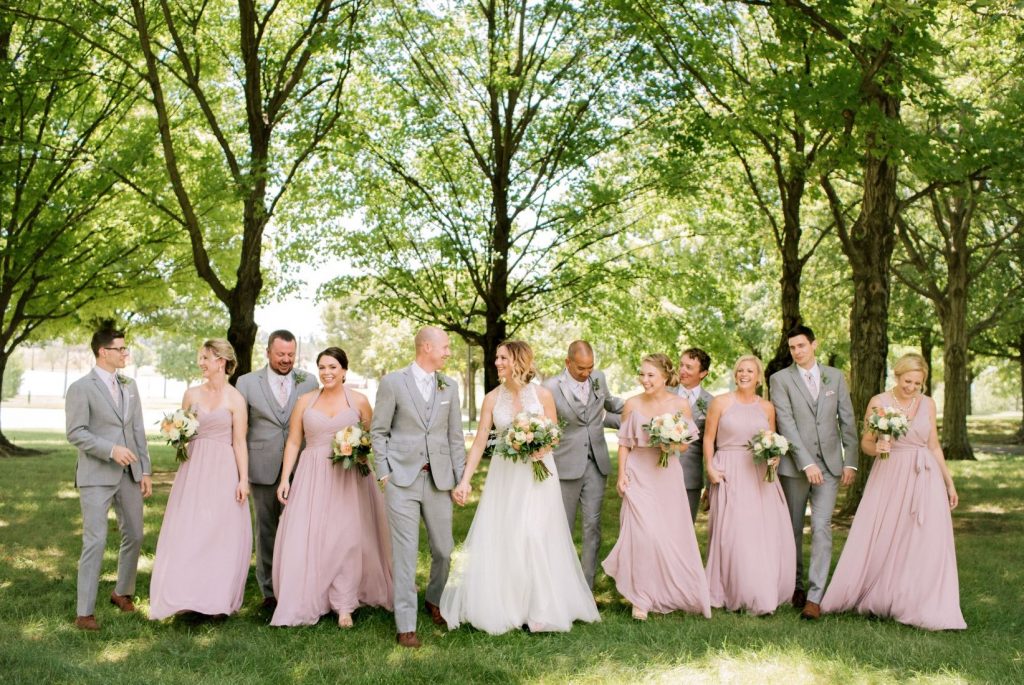 Spring wedding: what to wear - Groomsmen in heather gray suits next to bridesmaids in pink