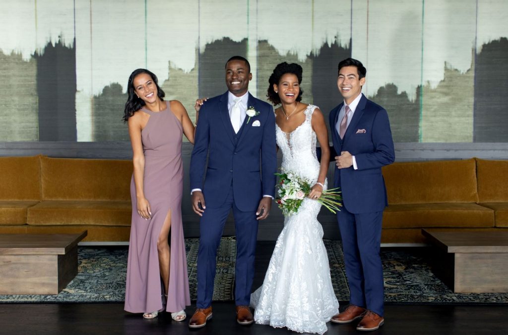 What to wear to a spring wedding - Men in blue suits, bride, bridesmaid in pink
