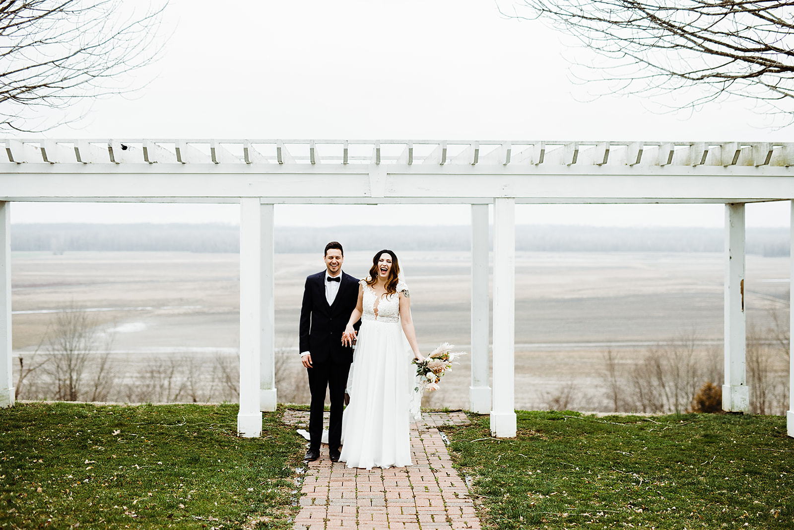 minimony or microwedding - bride and groom under a trellis