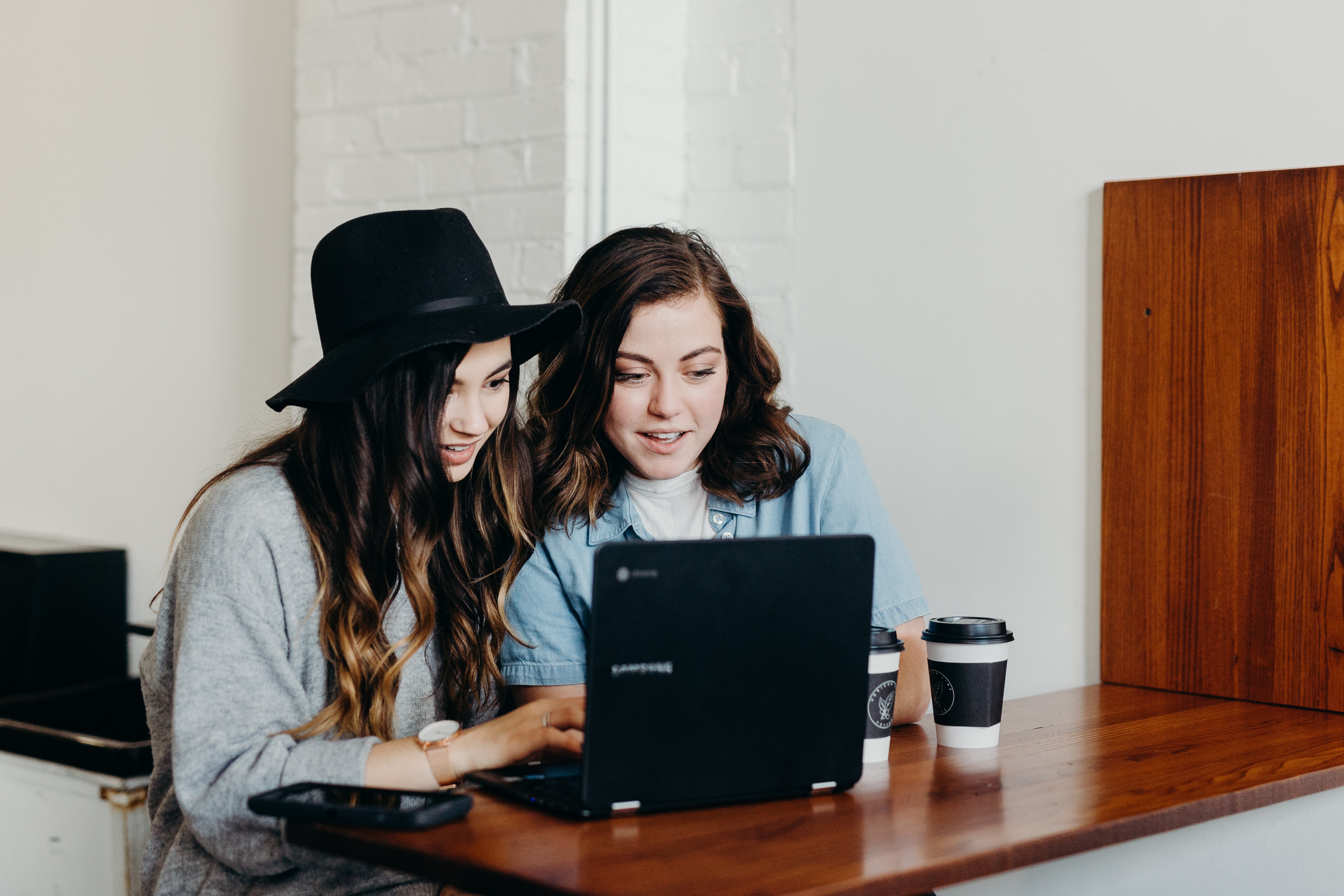 when your wedding vendor cancels - two women working on a computer